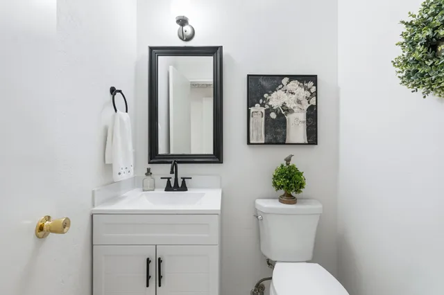 a bathroom with a toilet sink and mirror
