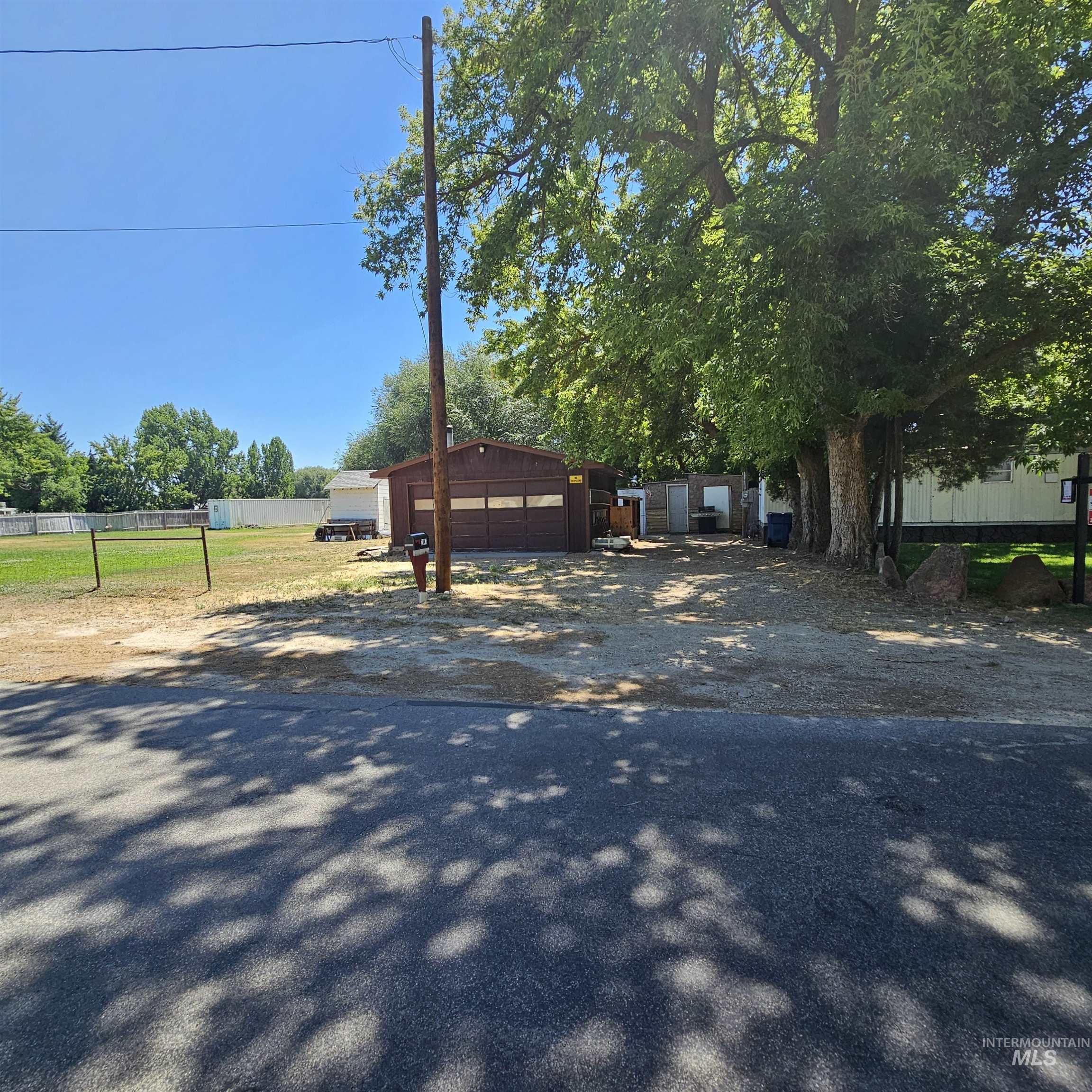 2141 East Syringa Street Eagle, ID 83616 - Photo 12 of 26 View of front of house featuring a detached garage, driveway, and an outdoor structure