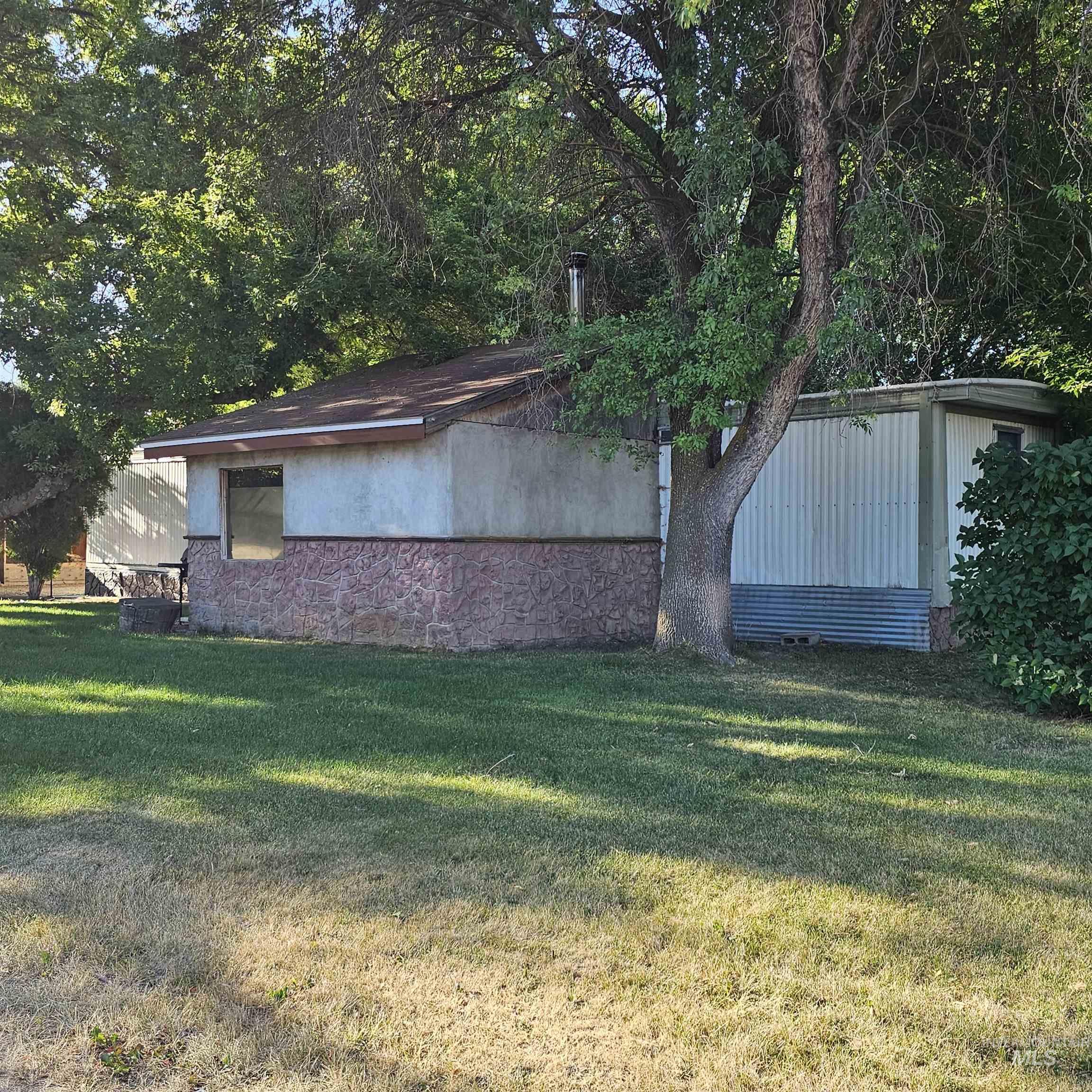 2141 East Syringa Street Eagle, ID 83616 - Photo 17 of 26 View of property exterior with a lawn