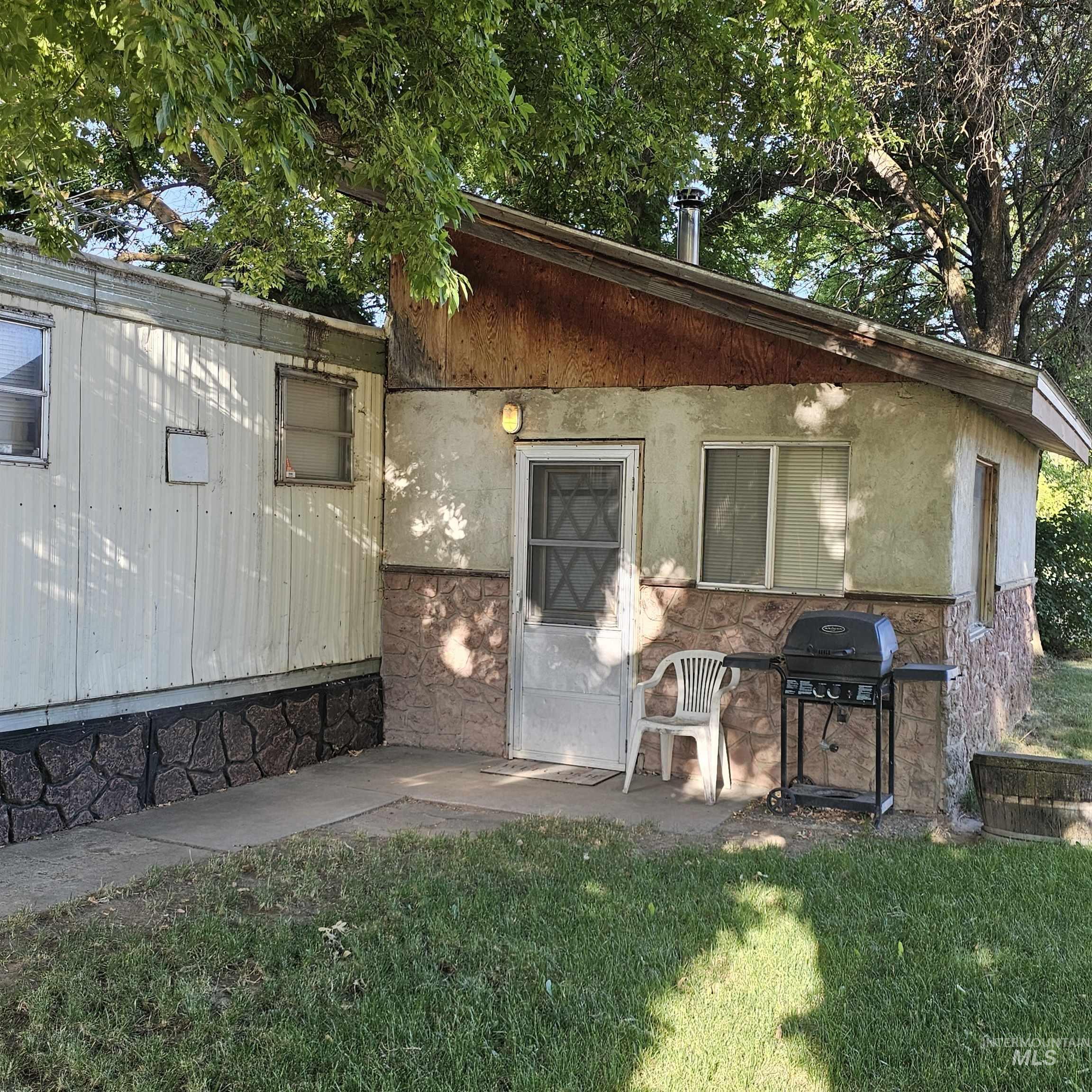 2141 East Syringa Street Eagle, ID 83616 - Photo 20 of 26 View of front of house featuring a front yard and stucco siding