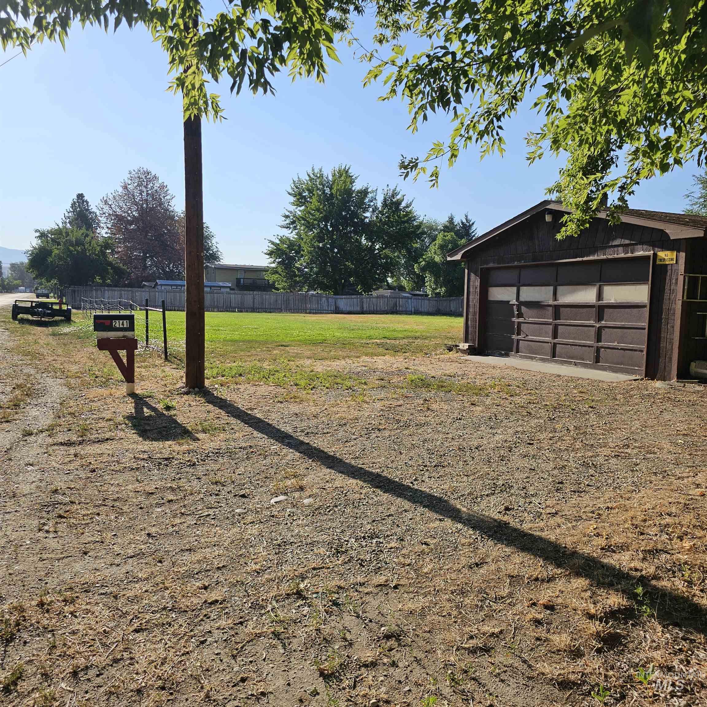 2141 East Syringa Street Eagle, ID 83616 - Photo 9 of 26 View of yard featuring an outdoor structure and a detached garage