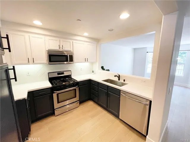 a kitchen with a sink stove and microwave
