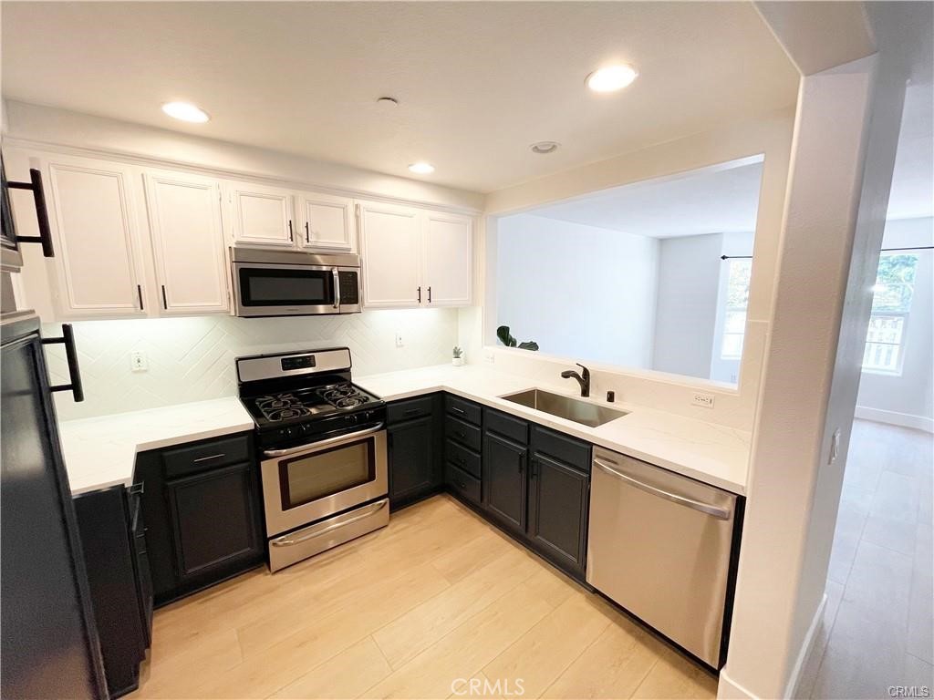 30 Three Vines Court Ladera Ranch, CA 92694 - Photo 11 of 36 a kitchen with a sink stove and microwave