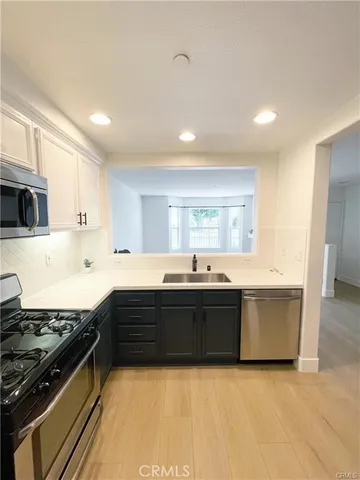 a large kitchen with stainless steel appliances granite countertop a stove and a sink