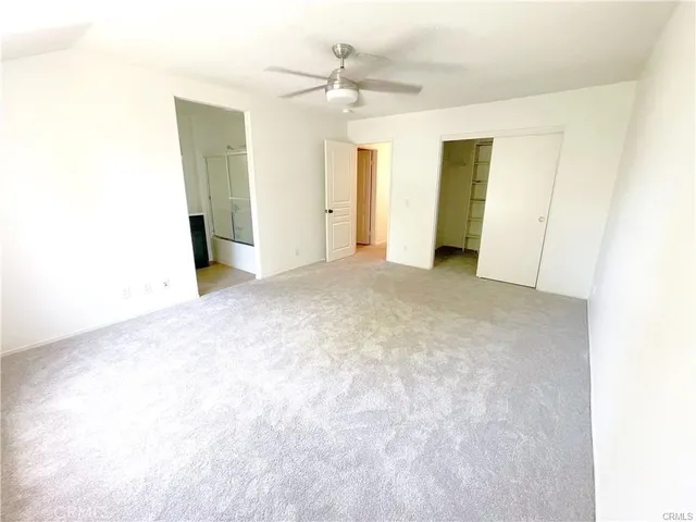 a view of an empty room with closet