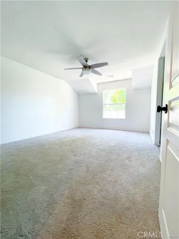 a view of a livingroom with a ceiling fan and window