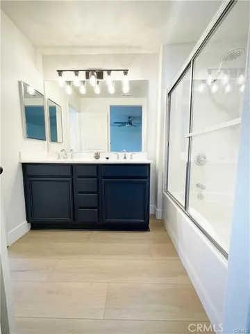 a bathroom with a sink vanity and mirror