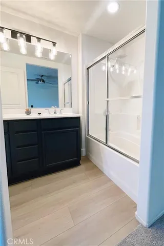 a bathroom with a sink vanity and mirror