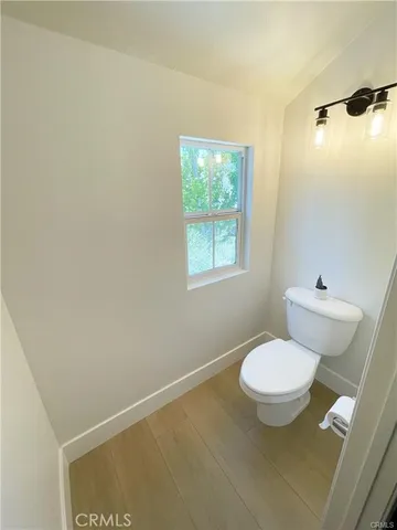 a view of bathroom with a toilet sink and a mirror