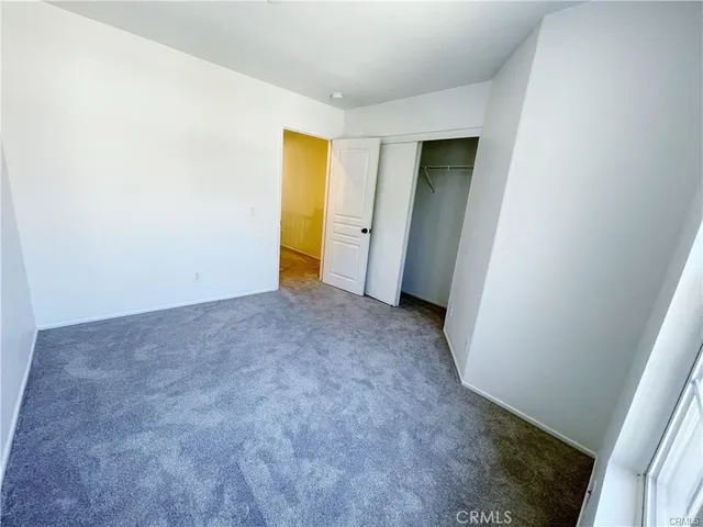 a view of an empty room with closet