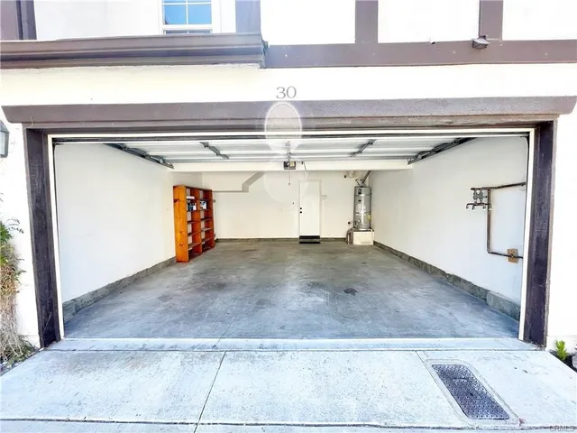 a view of a house with a tree and plants