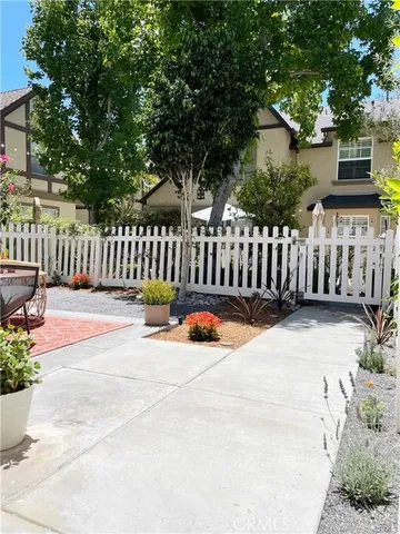 an empty room with wooden floor fireplace and windows