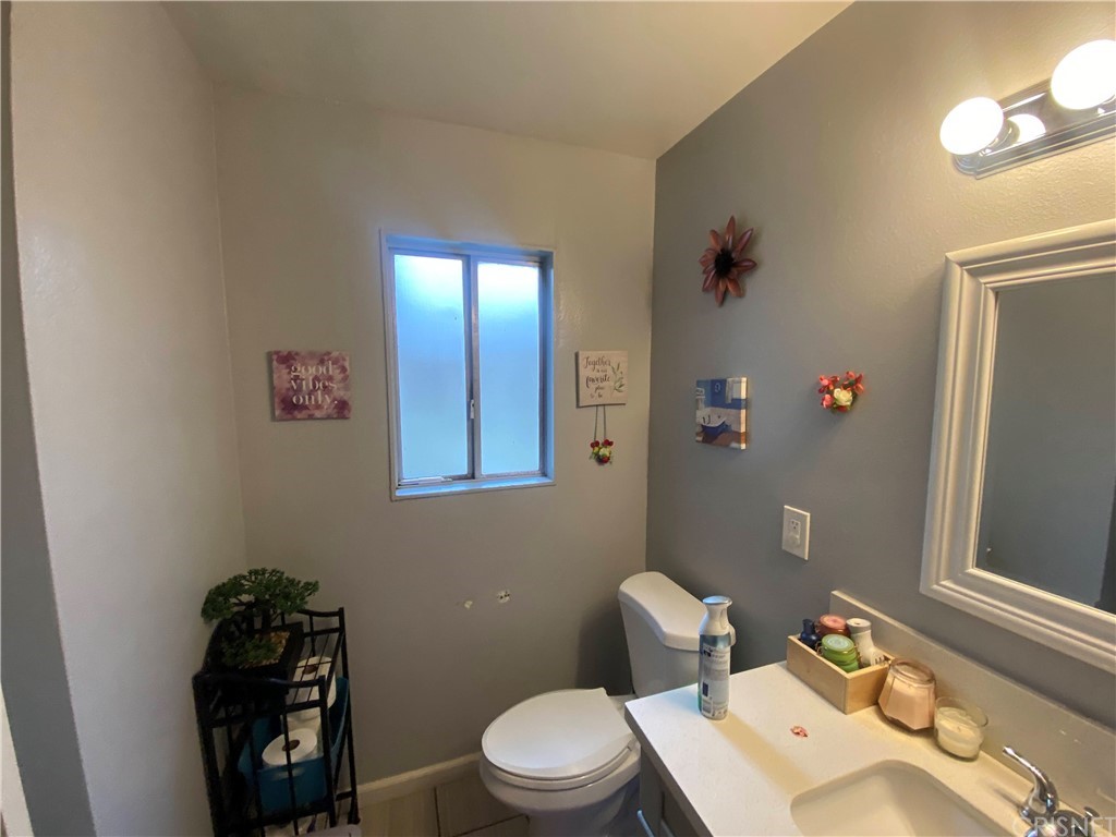 9 Ocotillo Lane Carson, CA 90745 - Photo 4 of 19 a bathroom with a toilet a sink and mirror