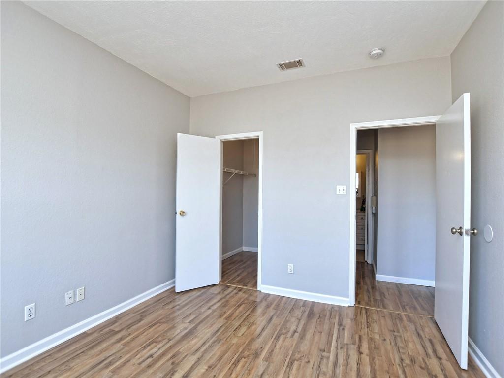 12166 Metric Boulevard, Unit 2015 Austin, TX 78758 - Photo 14 of 18 wooden floor in an empty room