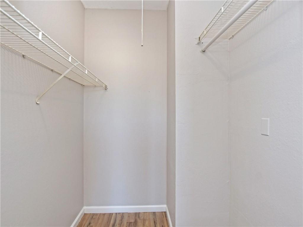 12166 Metric Boulevard, Unit 2015 Austin, TX 78758 - Photo 15 of 18 a view of a room with racks on the wall