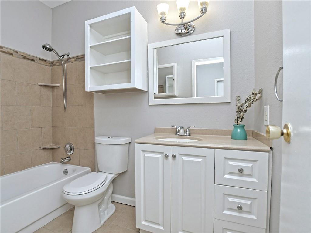 12166 Metric Boulevard, Unit 2015 Austin, TX 78758 - Photo 16 of 18 a bathroom with a sink a toilet and shower