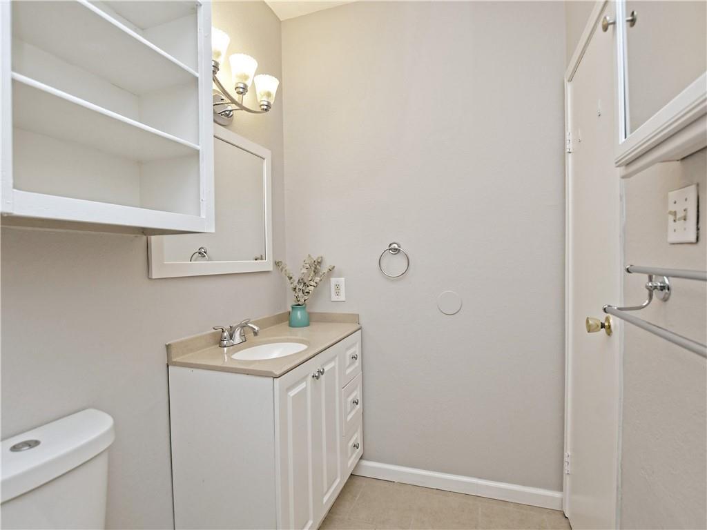 12166 Metric Boulevard, Unit 2015 Austin, TX 78758 - Photo 17 of 18 a bathroom with a sink a toilet and a mirror