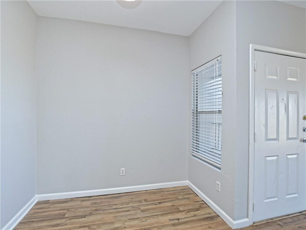 12166 Metric Boulevard, Unit 2015 Austin, TX 78758 - Photo 7 of 18 a view of an empty room with wooden floor and a window