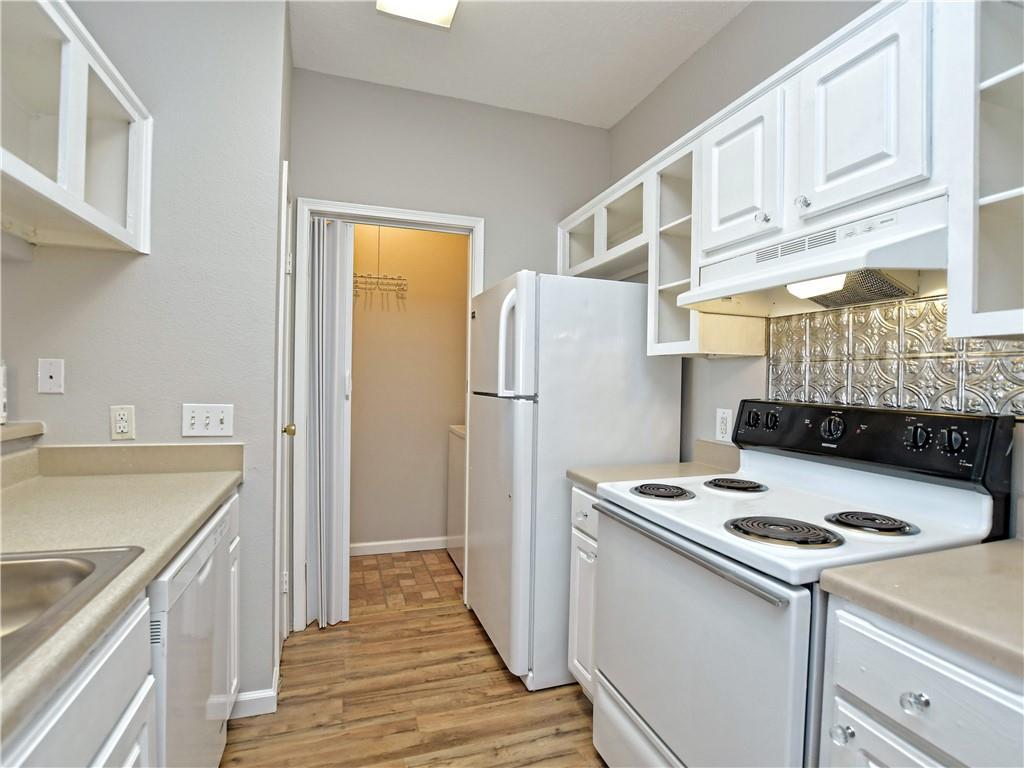 12166 Metric Boulevard, Unit 2015 Austin, TX 78758 - Photo 10 of 18 a kitchen with a refrigerator and a stove