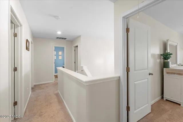 a view of entryway with white cabinets