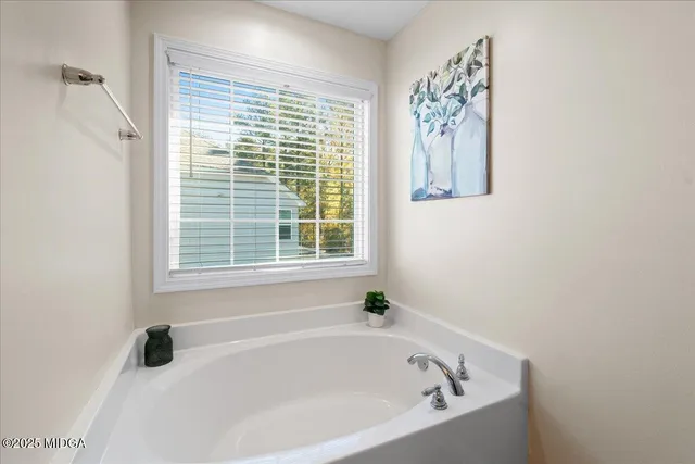 a white bath tub sitting next to a window