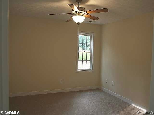 23 Winding Ridge Way Bumpass, VA 23024 - Photo 8 of 15 an empty room with windows and fan