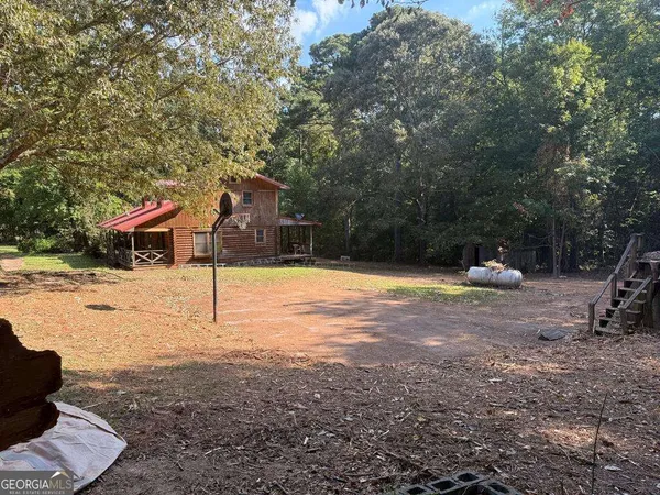 a backyard of a house with table and chairs