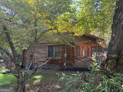 a front view of house with yard and trees