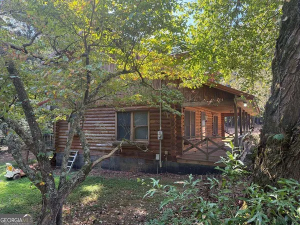 a front view of house with yard and trees