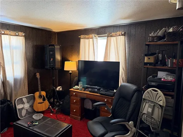 a room with furniture and flat screen tv