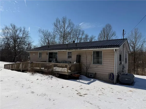 a view of a house with a yard covered in snow
