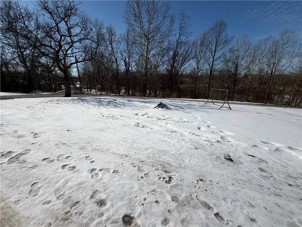a view of house with snow on the road