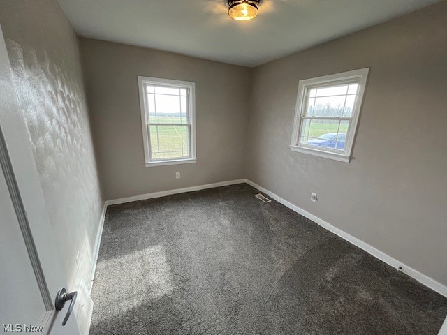 9660 Repp Road West Salem, OH 44287 - Photo 18 of 28 Carpeted empty room with a healthy amount of sunlight