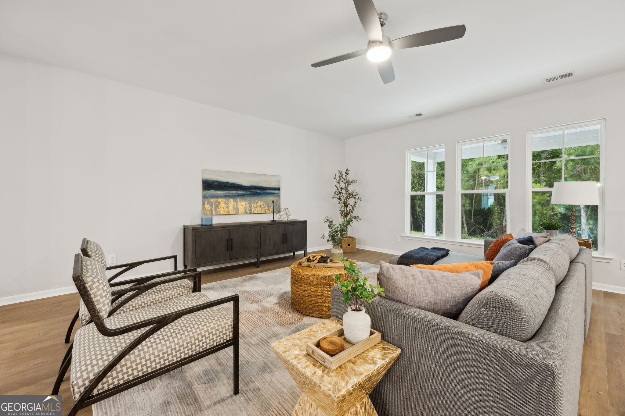 109 Tidal Marsh Way St. Marys, GA 31558 - Photo 11 of 71 a living room with furniture a large window and a chandelier