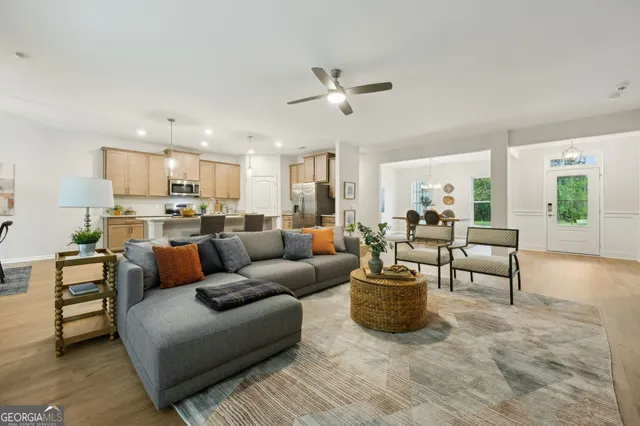 a kitchen with stainless steel appliances granite countertop a sink a stove a refrigerator a center island and cabinets