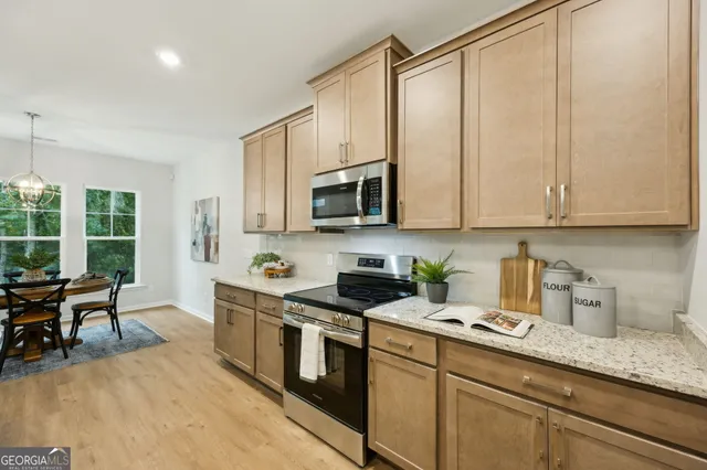 a view of a dining room with furniture and chandelier