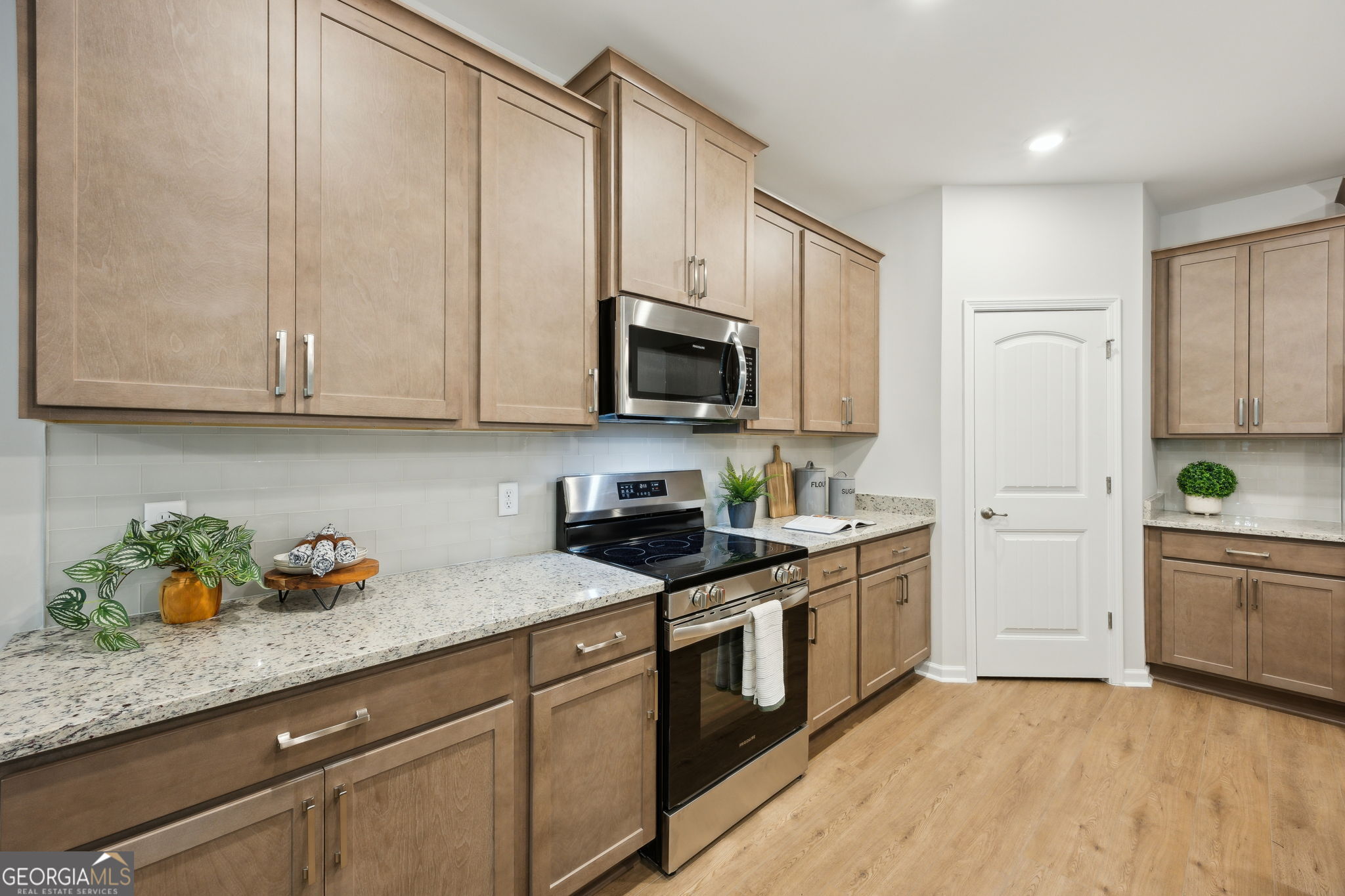 109 Tidal Marsh Way St. Marys, GA 31558 - Photo 17 of 71 a kitchen with stainless steel appliances granite countertop a sink a stove a microwave and cabinets
