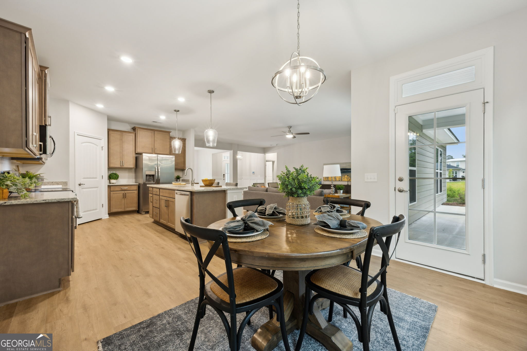 109 Tidal Marsh Way St. Marys, GA 31558 - Photo 20 of 71 a view of a dining room and a kitchen with a table chairs