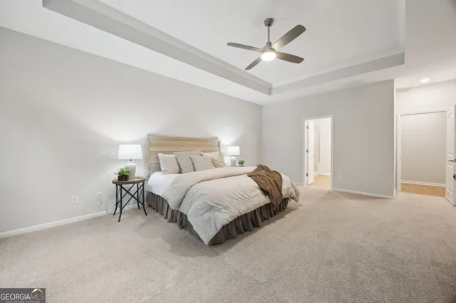 a large bed sitting in a bedroom next to a window