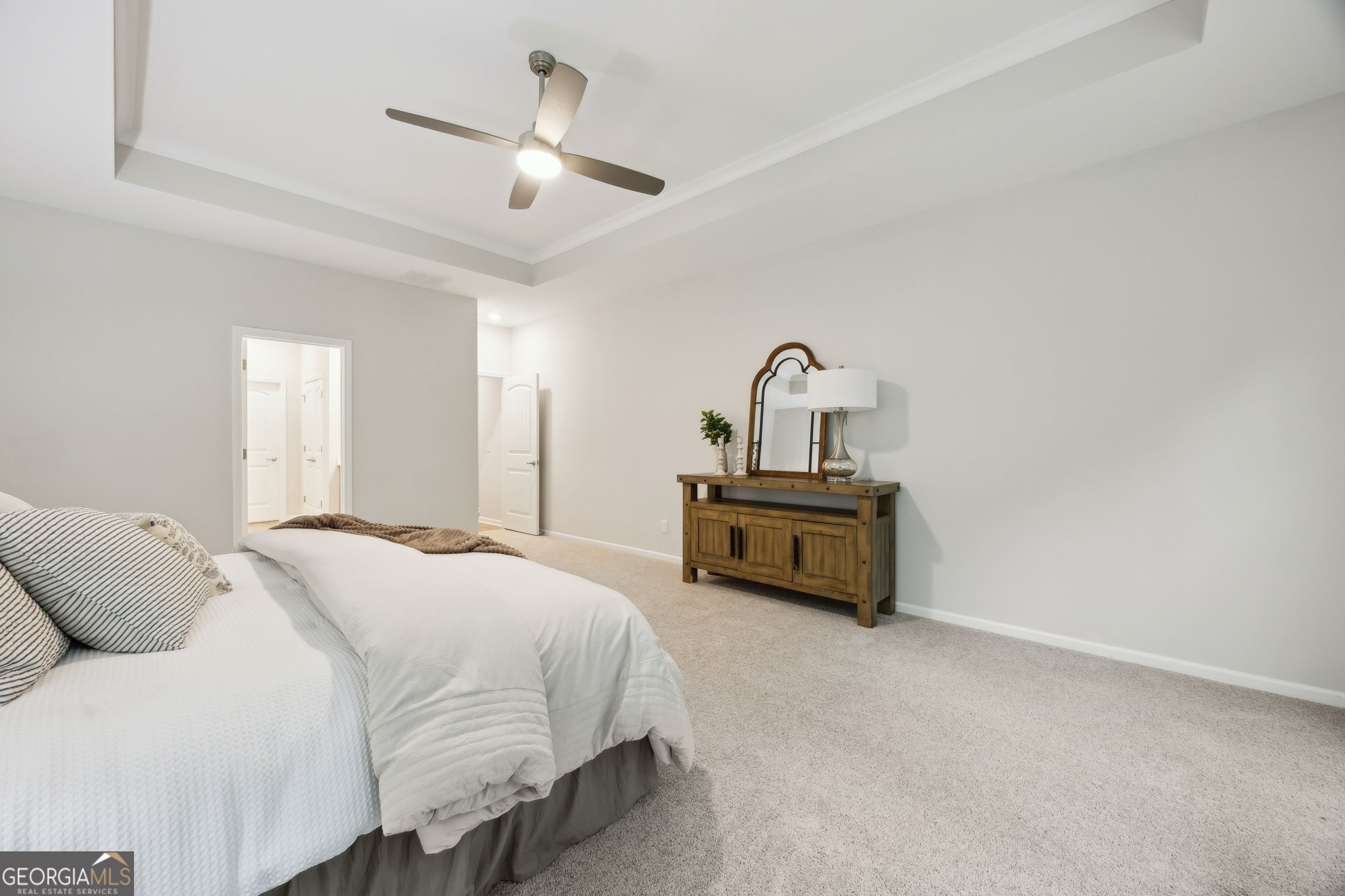 109 Tidal Marsh Way St. Marys, GA 31558 - Photo 29 of 71 a spacious bedroom with a bed and a chandelier
