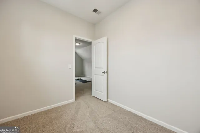 a kitchen with stainless steel appliances kitchen island granite countertop a table chairs in it and wooden floors