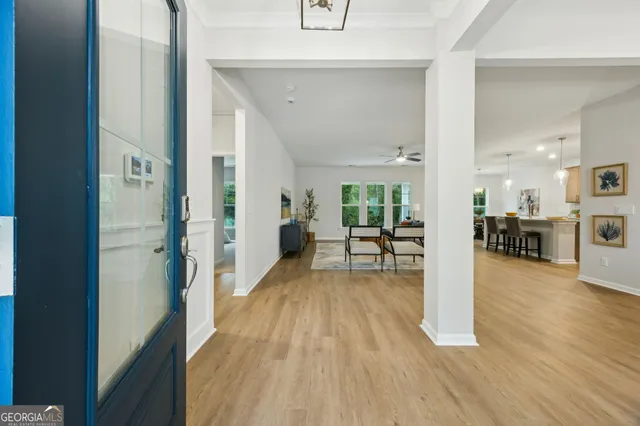 a view of a livingroom with wooden floor windows and a livingroom
