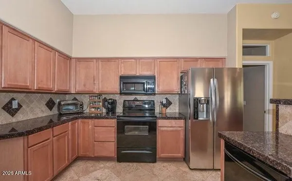 a bathroom with a granite countertop sink a toilet and a mirror