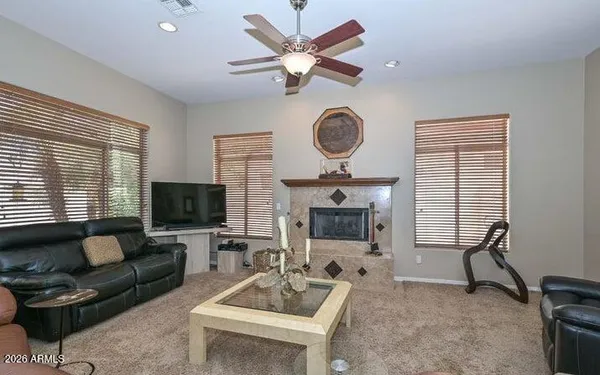 a living room with furniture a fireplace and a large window