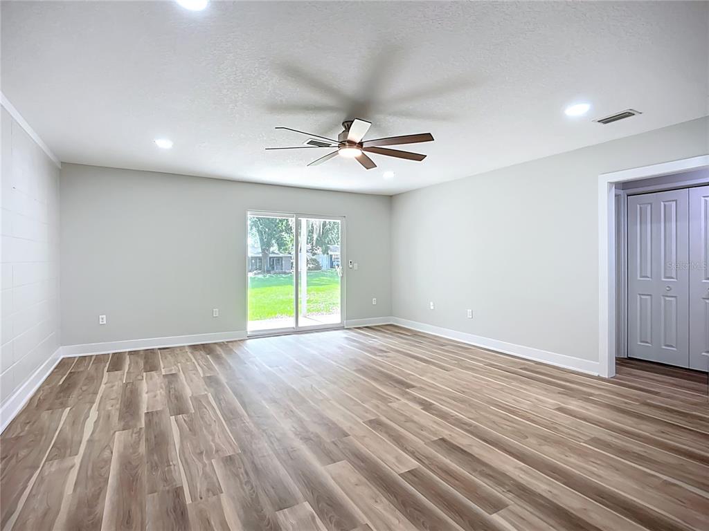 1307 Eagleview Drive Brandon, FL 33510 - Photo 13 of 27 wooden floor in an empty room with a window