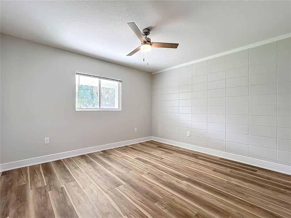 1307 Eagleview Drive Brandon, FL 33510 - Photo 19 of 27 wooden floor in an empty room with a window