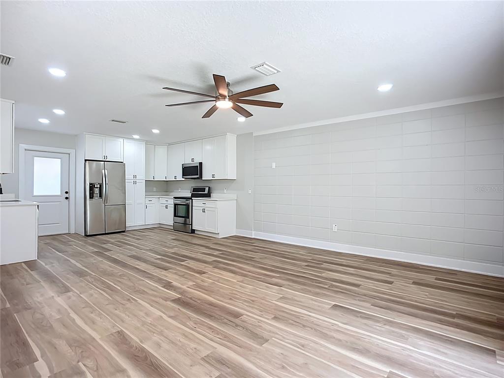 1307 Eagleview Drive Brandon, FL 33510 - Photo 10 of 27 a view of a kitchen with a stove cabinets and wooden floor