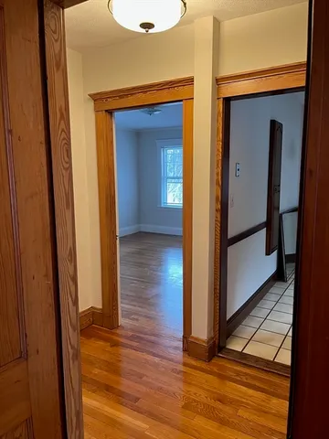 a view of hallway with wooden floor