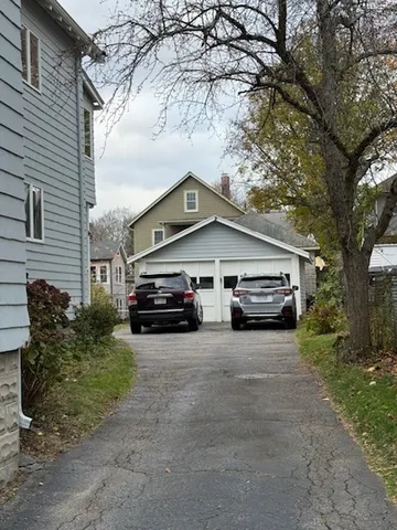 a car parked in front of white house
