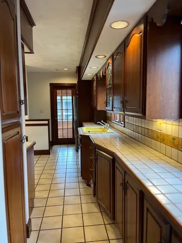 a kitchen with stainless steel appliances granite countertop a sink and wooden cabinets